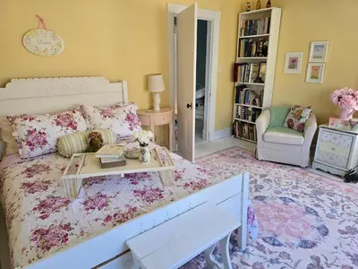a bedroom with a bed and a table and a chair at Captain Tiffany's in Saugerties
