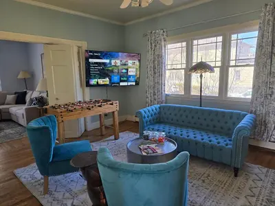 a living room with a blue couch and a table at Captain Tiffany's in Saugerties