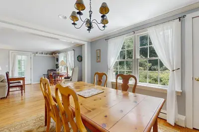 a dining room with a wooden table and chairs at The Village House in Manchester
