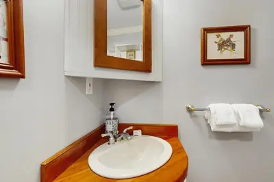 a bathroom with a sink and a mirror at The Village House in Manchester