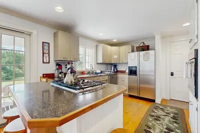 a kitchen with a counter and a stove top oven at The Village House in Manchester