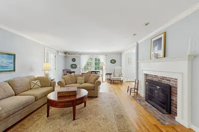 a living room with a couch and a fireplace at The Village House in Manchester