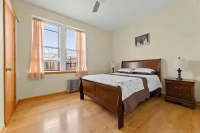 a bedroom with a bed and a large window at Immaculate furnished 1-Bedroom Apartment in Sunnyside