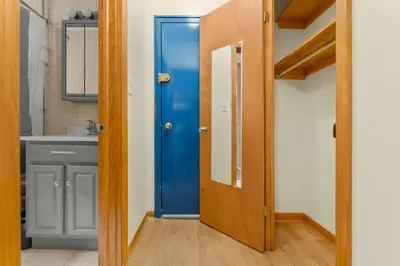 a bathroom with a blue door and a sink at Immaculate furnished 1-Bedroom Apartment in Sunnyside