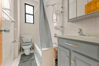a bathroom with a toilet and a sink and a shower at Immaculate furnished 1-Bedroom Apartment in Sunnyside