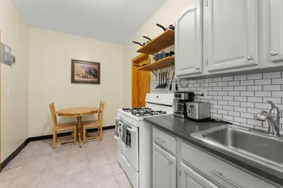 a kitchen with a sink and a stove top oven at Immaculate furnished 1-Bedroom Apartment in Sunnyside