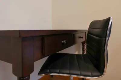 a black chair sitting in front of a desk at Immaculate furnished 1-Bedroom Apartment in Sunnyside
