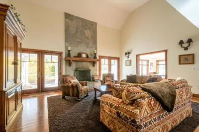 a living room with a couch and a fireplace at Mt Snow Convenience! Steps from the lifts! Hot Tub in Dover