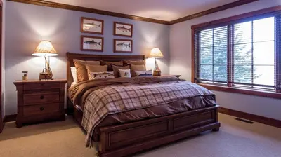 a bedroom with a bed and two lamps and a window at Mt Snow Convenience! Steps from the lifts! Hot Tub in Dover