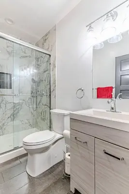 a bathroom with a toilet and a shower and a sink at Bergen County NYC Bus Malls in Maywood