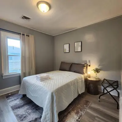 a bedroom with a white bed and a window at Private Bedroom w Shared Space A in South Hackensack
