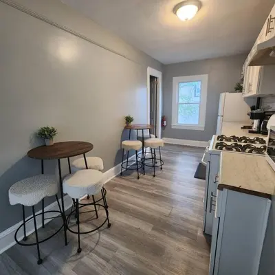 a kitchen with four bar stools and a counter at Private Bedroom In Shared Apt C in South Hackensack