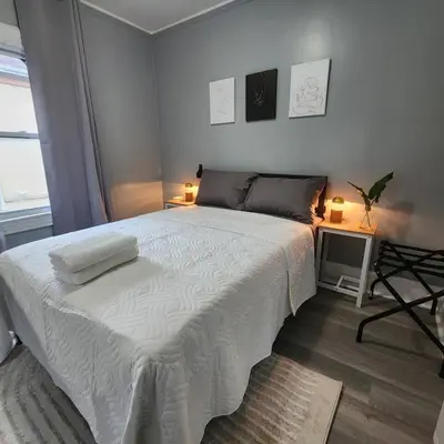 a bedroom with a large white bed with two lamps at Private Bedroom In Shared Apt C in South Hackensack