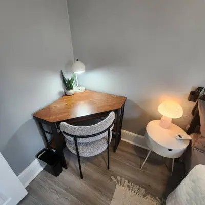 a dining room table with a lamp and a chair at Private Bedroom In Shared Apt C in South Hackensack