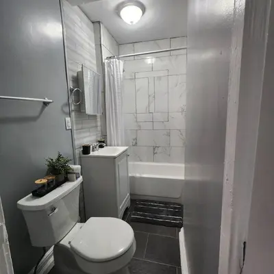 a bathroom with a toilet and a sink and a tub at Private Bedroom In Shared Apt B in South Hackensack