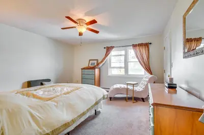a bedroom with a bed and a ceiling fan at 2 Blocks to Beach Walkable Woodmont Village Home in Milford