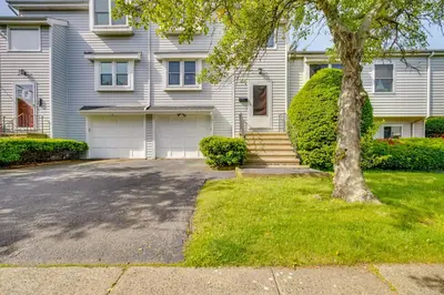 a white house with a tree and a driveway at 2 Blocks to Beach Walkable Woodmont Village Home in Milford