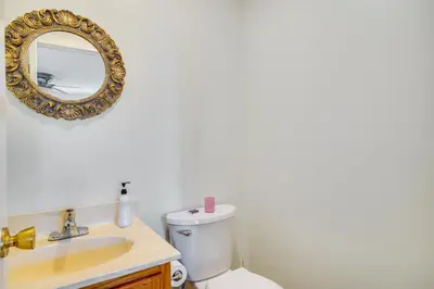 a bathroom with a sink and a toilet and a mirror at 2 Blocks to Beach Walkable Woodmont Village Home in Milford