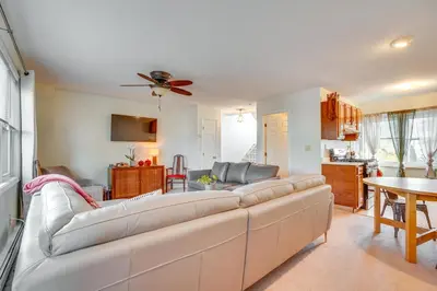 a living room with a couch and a table at 2 Blocks to Beach Walkable Woodmont Village Home in Milford
