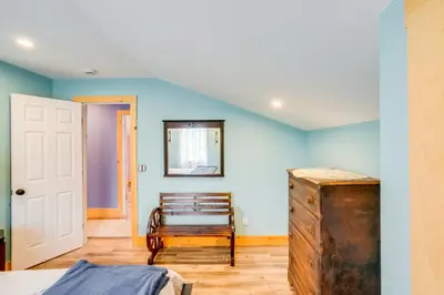 a bedroom with blue walls and a wooden dresser at 4 Mi to Dtwn Catskill Mtn-View Home in Catskill