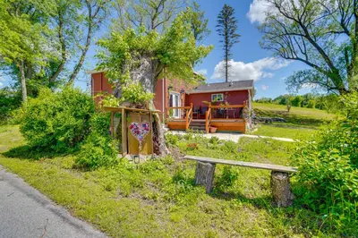 a red house with a bench in front of it at 4 Mi to Dtwn Catskill Mtn-View Home in Catskill
