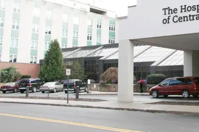 a hospital building with cars parked in a parking lot at 5•Star Fave CapeCodStyle Gem with Bedroom on Main in New Britain