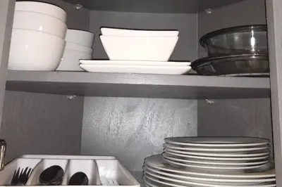 a kitchen shelf with plates and bowls and dishes at 5•Star Fave CapeCodStyle Gem with Bedroom on Main in New Britain
