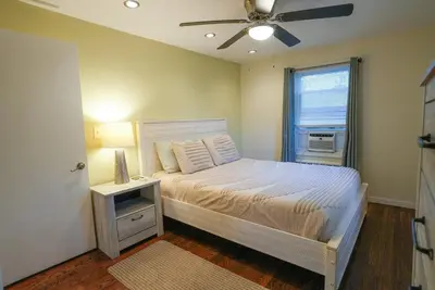 a bedroom with a bed and a ceiling fan at 5•Star Fave CapeCodStyle Gem with Bedroom on Main in New Britain