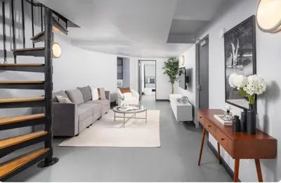 a living room with a couch and a table at Spacious 4Bd with Backyard in Manhattan in New York