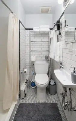 a small bathroom with a toilet and a sink at Spacious 4Bd with Backyard in Manhattan in New York