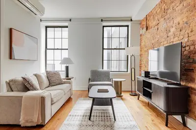 a living room with a couch and a tv at Blueground Downtown Brooklyn rooftop nr Fort Greene Park NYC-1832 in Brooklyn