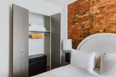 a bedroom with a brick wall and a bed at Blueground Downtown Brooklyn rooftop nr Fort Greene Park NYC-1832 in Brooklyn