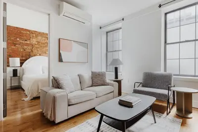 a living room with a couch and a bed at Blueground Downtown Brooklyn rooftop nr Fort Greene Park NYC-1832 in Brooklyn