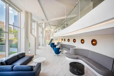 a lobby of a building with couches and chairs at Blueground Lincoln Square rooftop nr Central Park NYC-1217 in New York