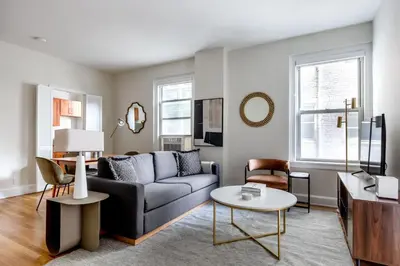 a living room with a couch and a table at Blueground Lenox Hill view nr Central Park NYC-1303 in New York