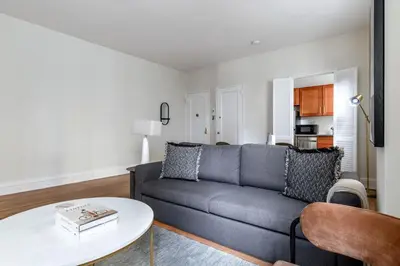 a living room with a couch and a table at Blueground Lenox Hill view nr Central Park NYC-1303 in New York