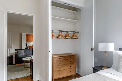 a bedroom with a closet with a bed and a desk at Blueground Lenox Hill view nr Central Park NYC-1303 in New York