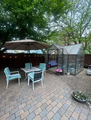 a patio with a table and chairs and an umbrella at Hudson Guest House in Jersey City