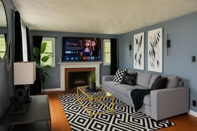 a living room with a couch and a tv at Cozy Home in New Britain