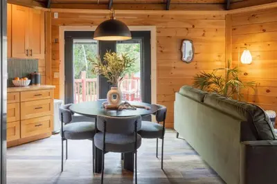 a dining room with a table and a couch at The Lily Pad - Hunter NY in Elka Park