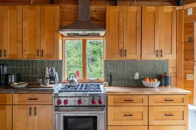 a kitchen with wooden cabinets and a stove top oven at The Lily Pad - Hunter NY in Elka Park