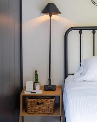 a lamp on a night stand next to a bed at The Lily Pad - Hunter NY in Elka Park