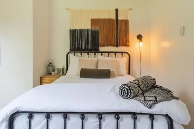 a bedroom with a bed with white sheets and pillows at The Lily Pad - Hunter NY in Elka Park