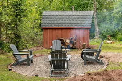 a group of chairs sitting in front of a cabin at The Lily Pad - Hunter NY in Elka Park