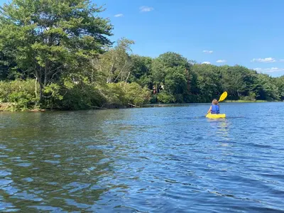 a person in a kayak on a lake at Lakeside Escape at StillwaterHot Tub & Ski in Pocono Summit