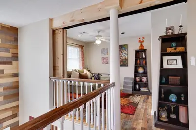 a staircase in a house with a living room at Lakeside Escape at StillwaterHot Tub & Ski in Pocono Summit