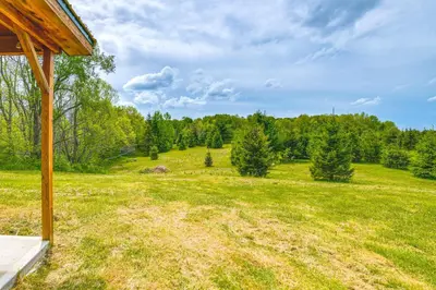 an open field with trees in the background at Escape to Nature Secluded McDonough Cabin!