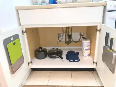 a kitchen cabinet with pots and pans and a sink at Chelsea Studio-Shared Bathroom with Kitchen Twin Bunk Bed in New York