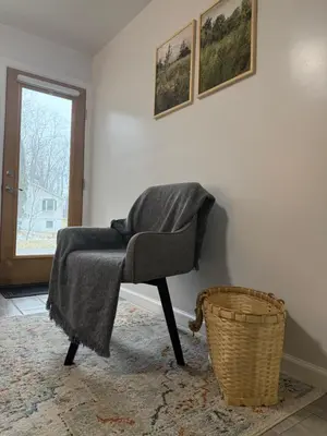 a chair with a blanket sitting in a room at Ultra Contemporary Loft in Scarsdale