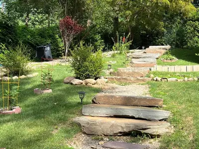 a garden with rocks in the grass at Ultra Contemporary Loft in Scarsdale